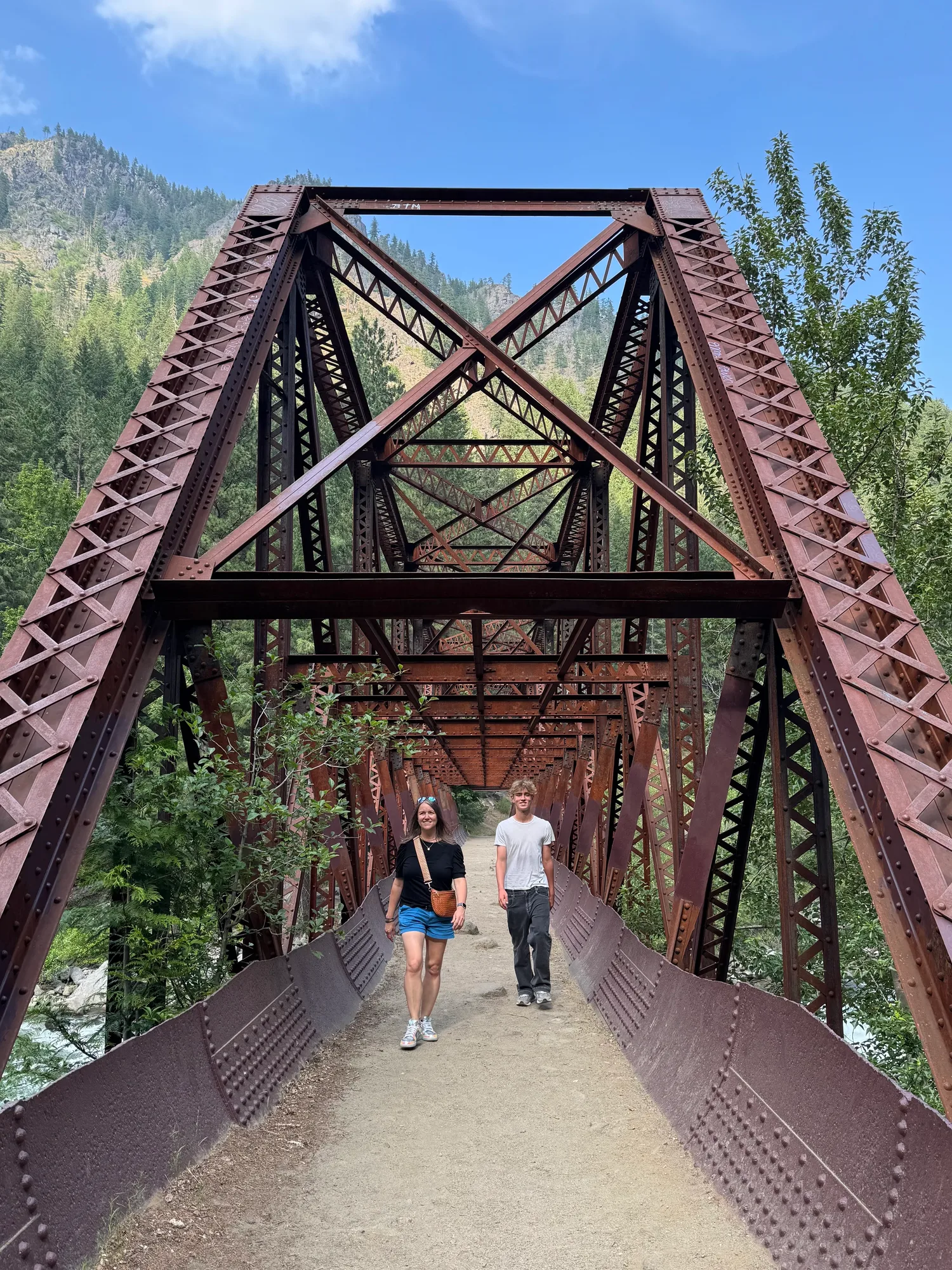 Crystal and one of the boys crossing an old railroad trestle bridge in the mountains on the way to Leavenworth