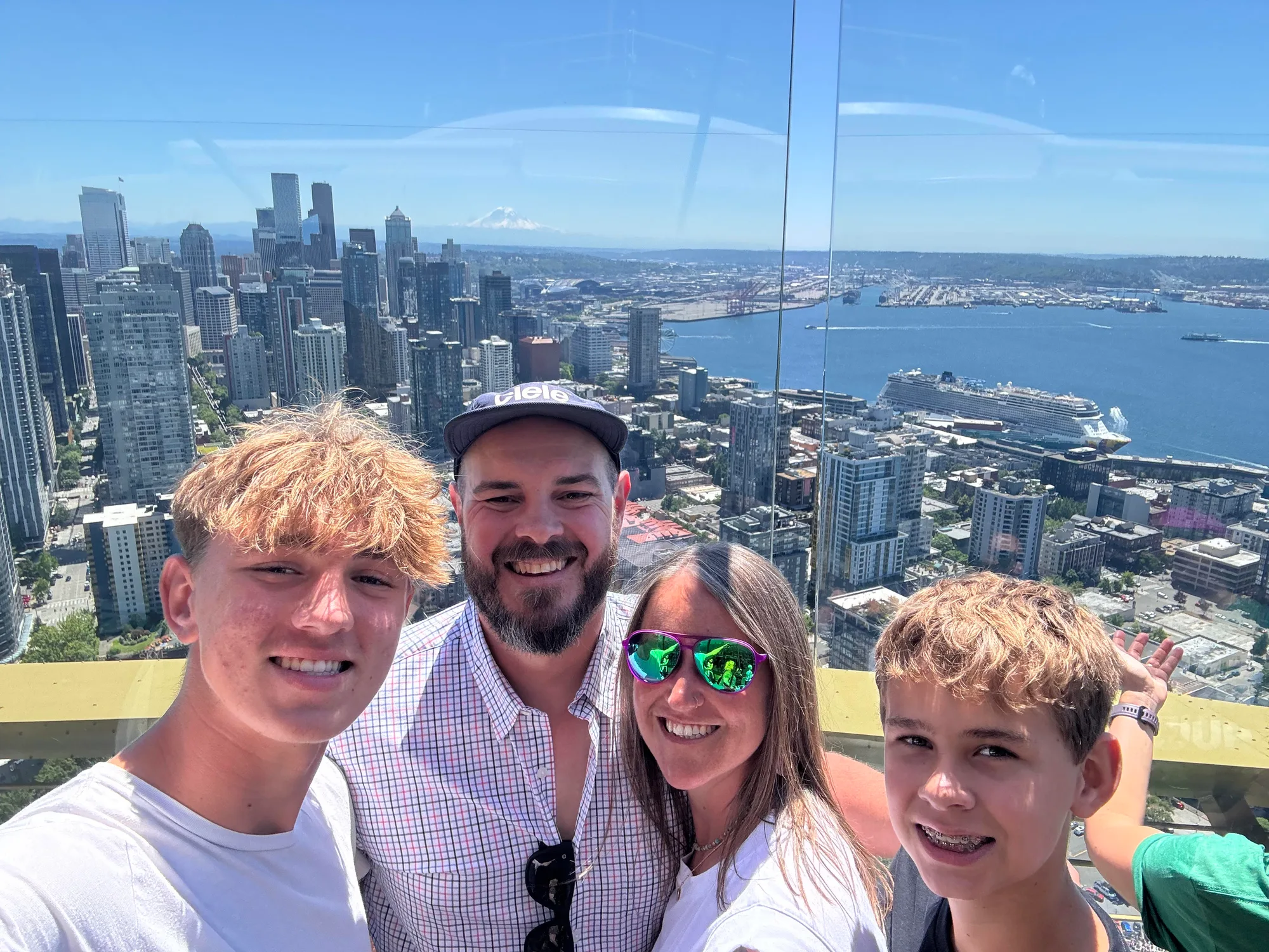 Crystal, the boys, and I on the Space Needle observation deck overlooking the Seattle skyline